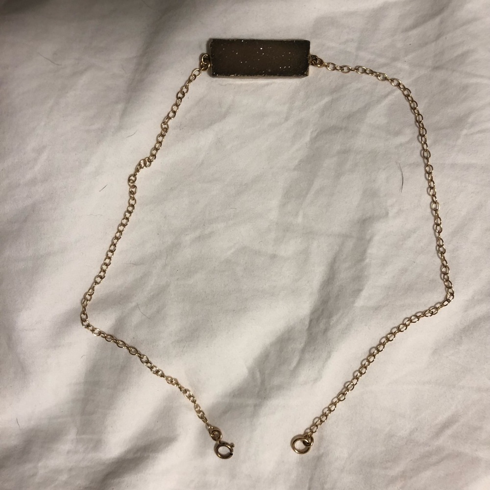 Gold necklace with gold rimmed crystal